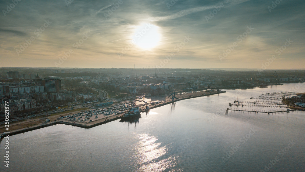 sunset over river - aerial view of the city of rostock sunset over river - aerial view of the city of rostock