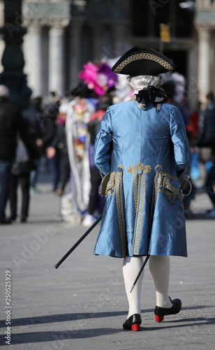 masked man with white wig and elegant blue Venetian noble dress