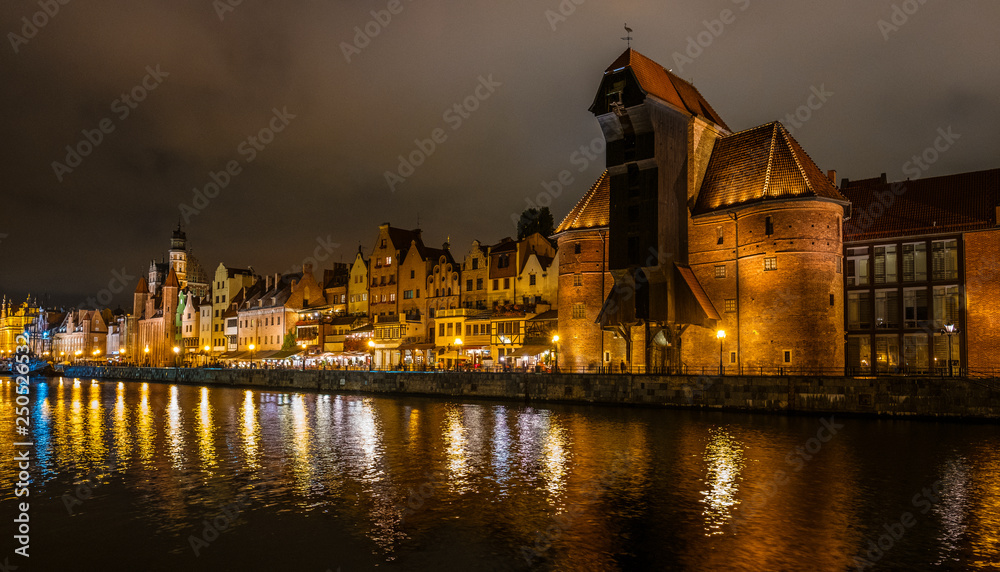 The dark view of Gdansk, old town and famous crane at amaizing night with light reflections. Poland