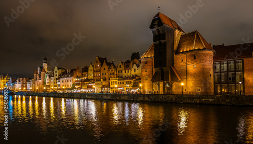 The dark view of Gdansk, old town and famous crane at amaizing night with light reflections. Poland