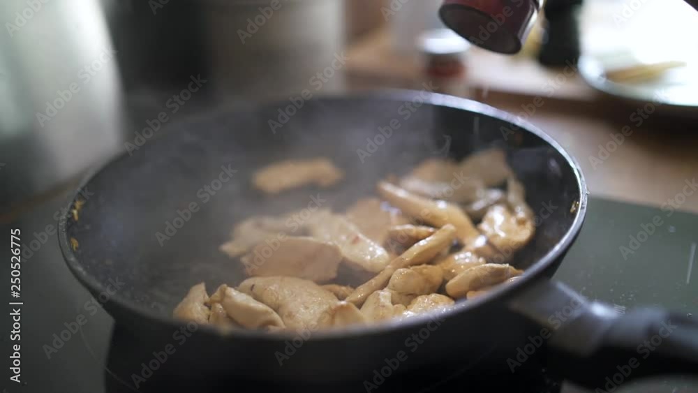 Closeup of food being cooked in fried pan (slow motion) Closeup of food being cooked in fried pan (slow motion)
