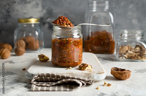 Homemade sauce adjika with vegetables and walnuts