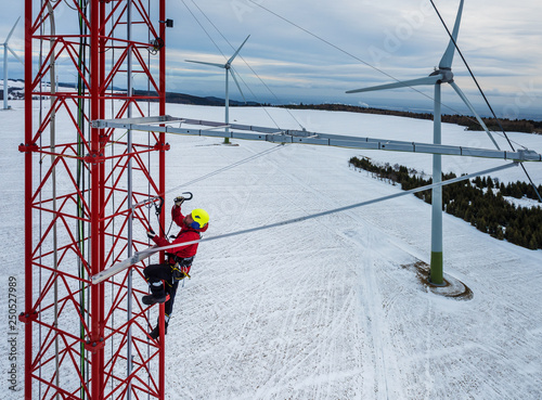 Worker climbing up on red industrial construction use safety harness, irata worker, rope access photo