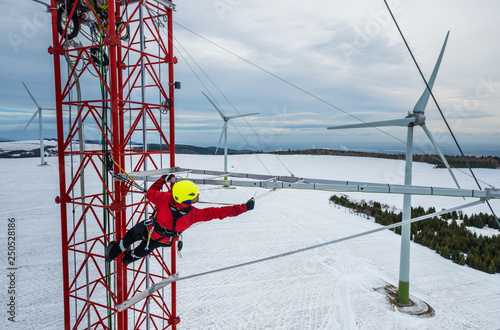 Worker climbing up on red industrial construction use safety harness, irata worker, rope access photo