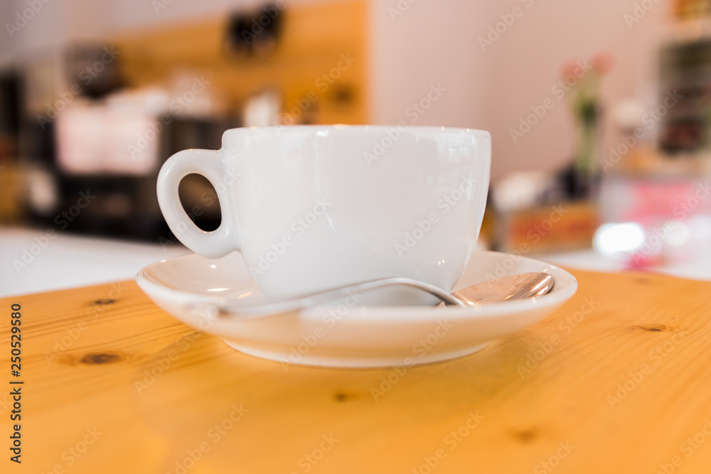 A white cup.of capuccino on wooden table A white cup.of capuccino on wooden table