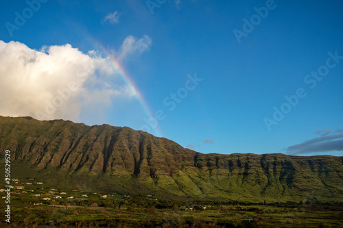 Makaha valley with a rainbow on a blue sky