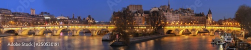 View of the Pont Neuf across the river Seine in Paris at night , France.