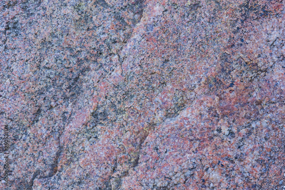 Texture of granite close up. Granite rock with reddish color. Background from solid stone. Pattern with natural material Texture of granite close up. Granite rock with reddish color. Background from solid stone. Pattern with natural material