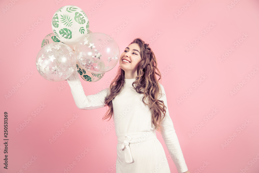 Young girl with balls on a colored background