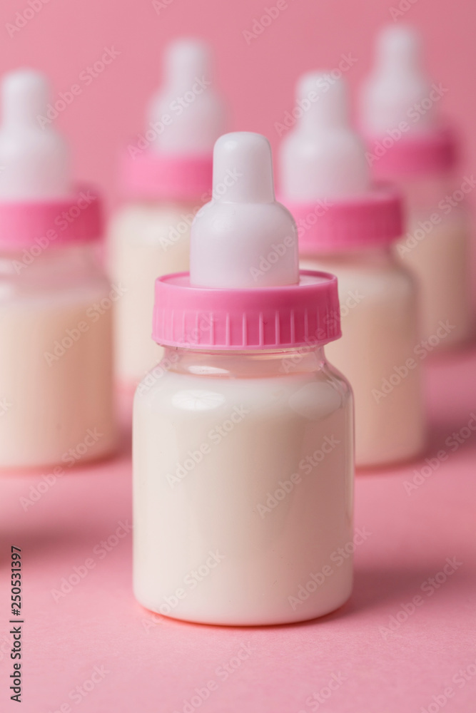 Baby bottle full of milk on a pink background Baby bottle full of milk on a pink background