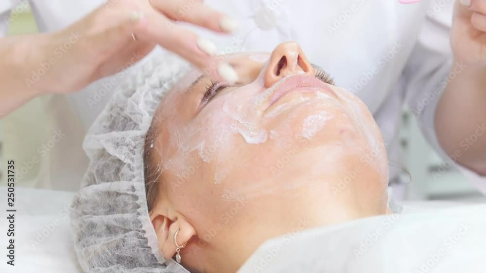 Mesotherapy. Cosmetologist applying the cream on the client's face doing cosmetic procedures cleaning of the face in cosmetology clinic. Mesotherapy. Cosmetologist applying the cream on the client's face doing cosmetic procedures cleaning of the face in cosmetology clinic.