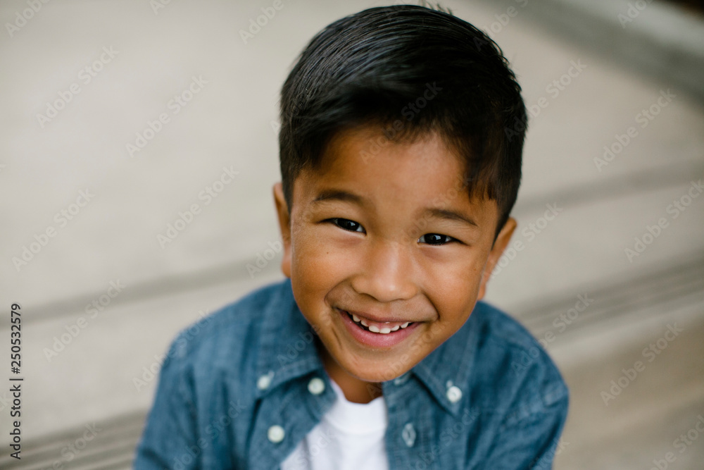 Portrait of smiling boy sitting on steps in Balboa Park Portrait of smiling boy sitting on steps in Balboa Park