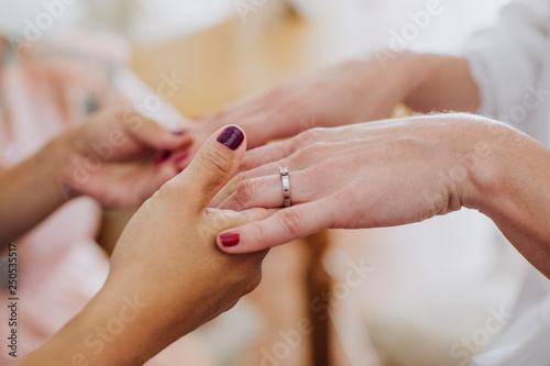 bride placing her wedding ring