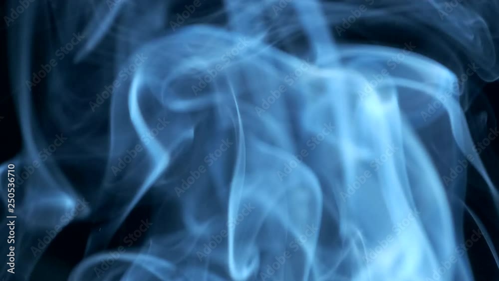 Smoke rising graceful twists on black background blowing from bottom to top. Closeup, ProRes, 50 fps Smoke rising graceful twists on black background blowing from bottom to top. Closeup, ProRes, 50 fps