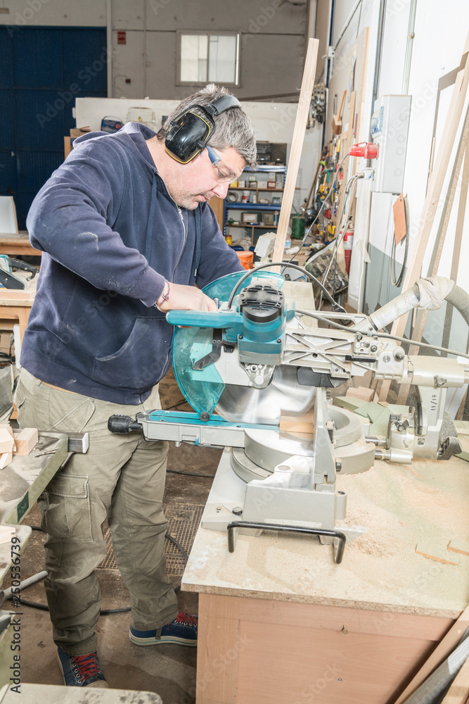 Male carpenter working in his carpentry workshop. Male carpenter working in his carpentry workshop.