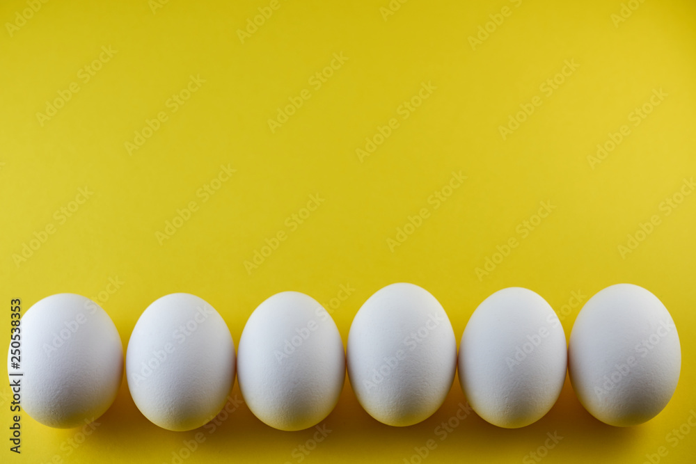 White eggs on the yellow background. Easter concept. Copy space. White eggs on the yellow background. Easter concept. Copy space.