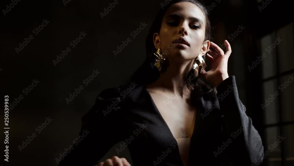 Portrait Of A Gentle Girl In A Stylish Blouse On A Black Background.