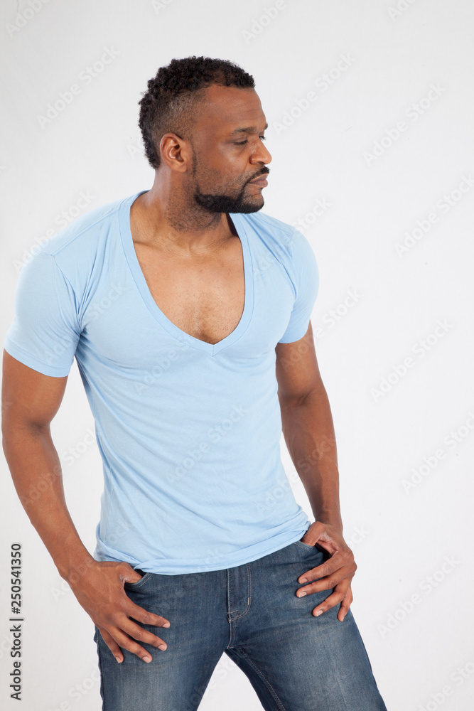 Handsome Black man in blue shirt, looking thoughtfully away Handsome Black man in blue shirt, looking thoughtfully away