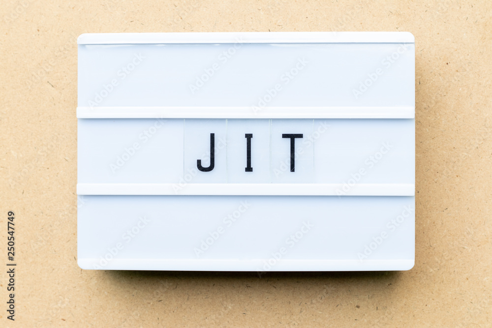 White lightbox with word JIT (abbreviation of just in time) on wood background White lightbox with word JIT (abbreviation of just in time) on wood background