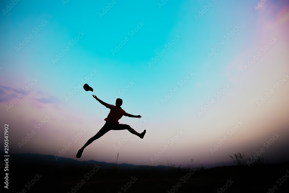 silhouettes; a man jumping in the sky