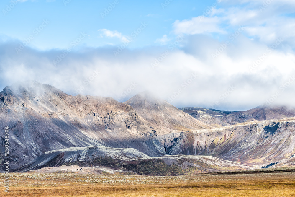 Landscape view of Laugarvatn mountains with clouds covering on golden circle in Iceland during day and blue color sky in autumn Landscape view of Laugarvatn mountains with clouds covering on golden circle in Iceland during day and blue color sky in autumn