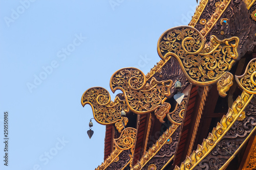 Beautiful craved naga pattern on the rafter and gable of the Thai's northern style church at Wat Chedi Liam, one of the ancient temple in the Wiang Kum Kam archaeological area, Chiang Mai, Thailand.
