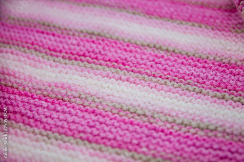 Pink, white and light brown striped knitted texture background © kapichka