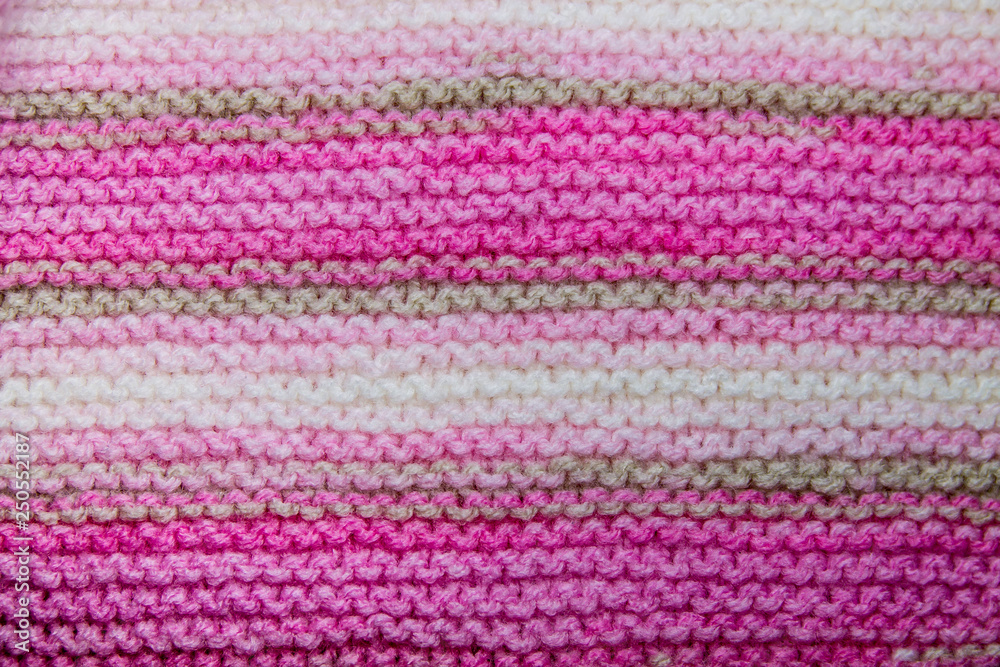 Pink, white and light brown striped knitted texture background