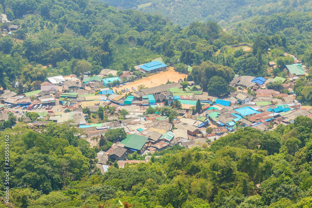 Doi Pui’s Hmong ethnic hill-tribe village, aerial view from the cliff with green forest on the mountain background. Doi Pui Hmong tribal village is located on Doi Suthep-Pui national park, Chiang Mai.