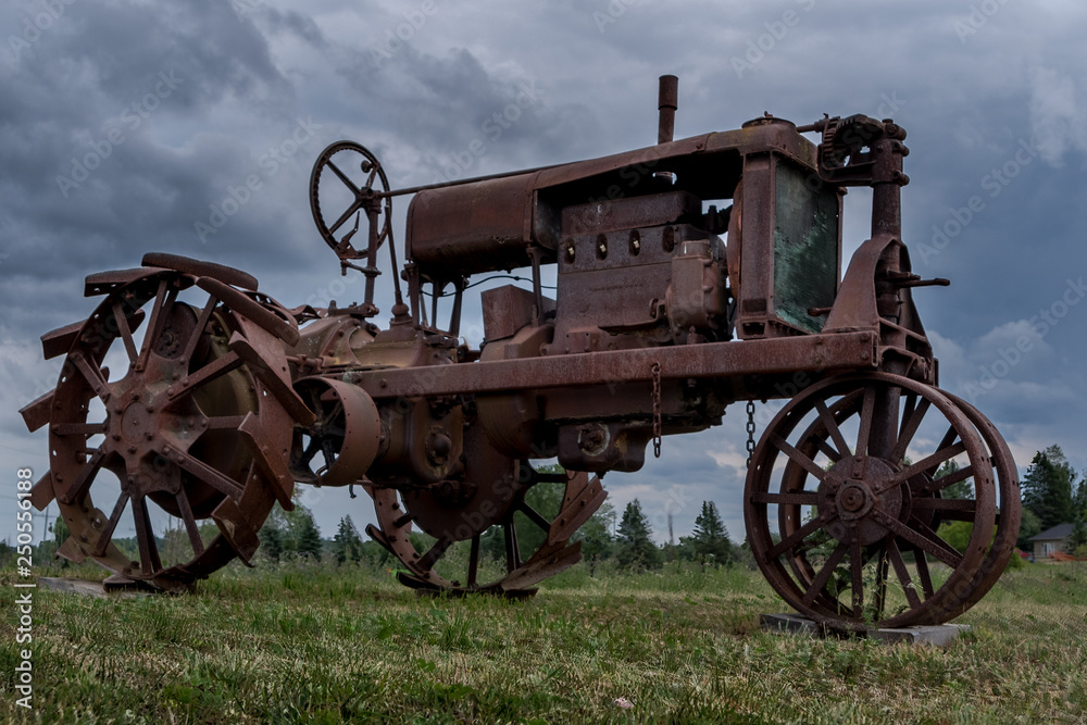 Old farm tractor sitting in a field