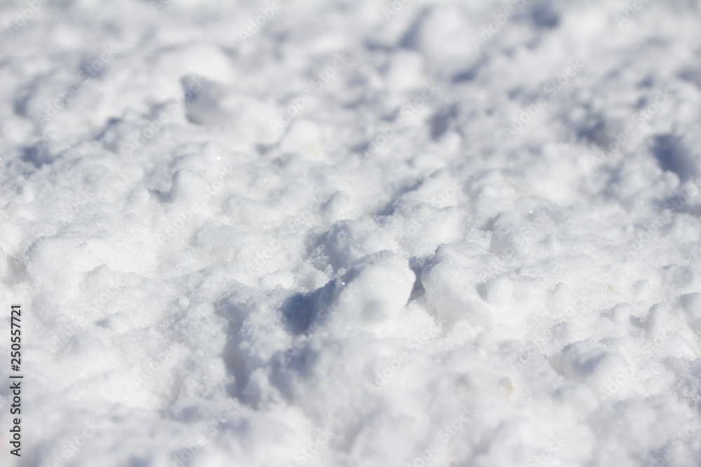 Close-up view of snow textures featured in deep banks of shoveled snow