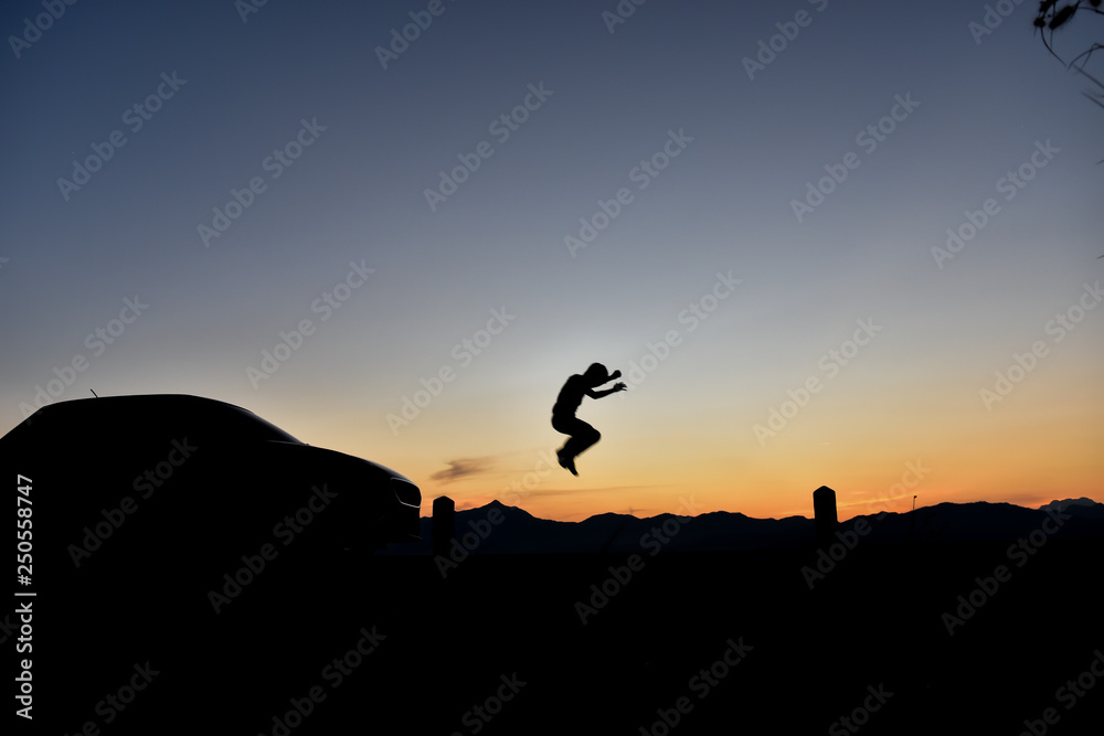 Silhouette of a jumping man at sunset, Concept lifestyle freedom vacation travel.