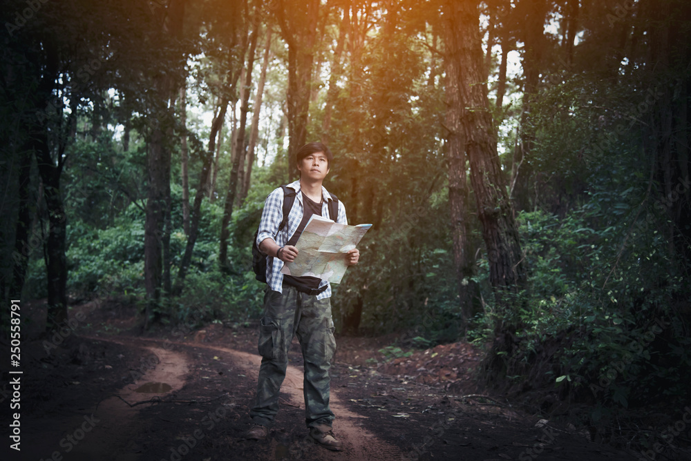 Obraz premium Young Man Traveler with backpack relaxing outdoor with rocky mountains on background Summer vacations and Lifestyle hiking concept