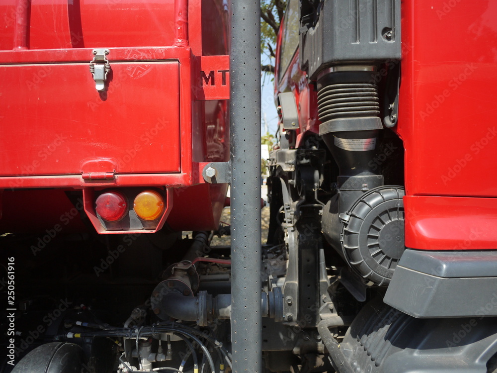 A part of fire truck. The automobile engine is all red. A part of fire truck. The automobile engine is all red.