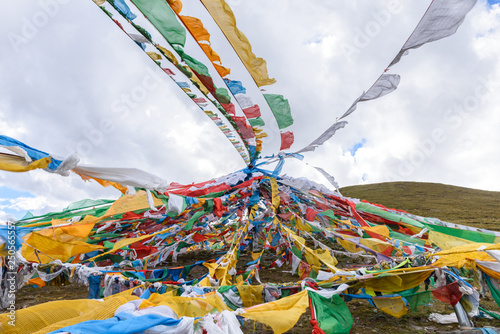 Colorful prayer flags at the Mila Mountain Pass (between the Lhasa Prefecture and the Nyingchi Prefecture) at the altitude of 5200m ,Tibet, China. photo