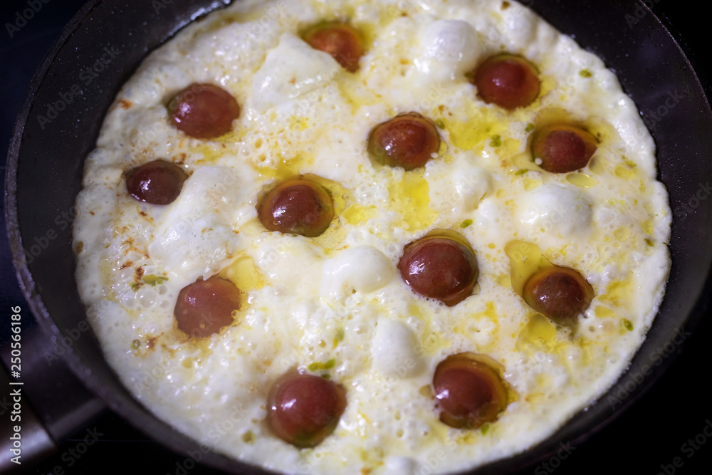 Omelet with cherry tomatoes in pan. Omelette Omelet with cherry tomatoes in pan. Omelette
