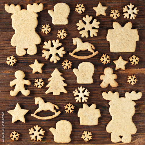 flat layout of festive figure handmade cookies on the dark wooden surface top view
