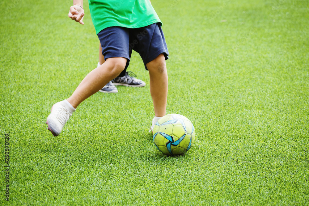 Kids running and kicking soccer ball Kids running and kicking soccer ball