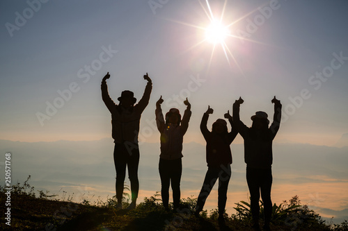 Silhouette group of young woman having fun outdoors  sunrise