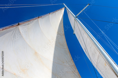Big white sail, sail on a boat, blue sky