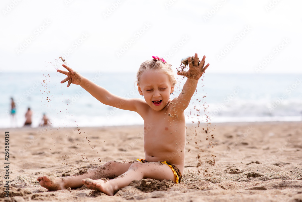 Child playing on tropical beach. Little girl at sea shore. Family summer  vacation. Kids play with water and sand toys. Ocean and island fun. Travel  with young children. Asia holiday. Stock Photo