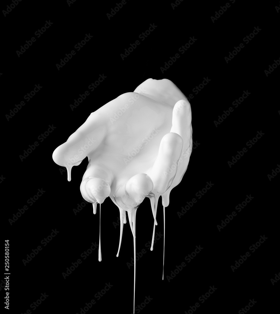 concept image of white paint dripping on female hand Stock Photo
