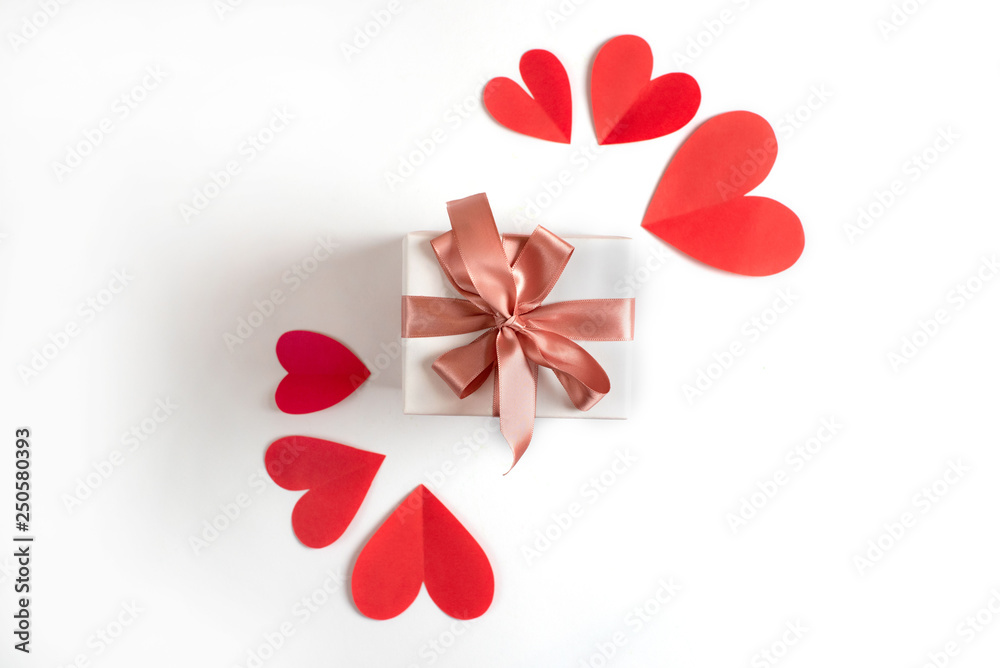 Box with a gift on the background of red hearts White isolated background Box with a gift on the background of red hearts White isolated background