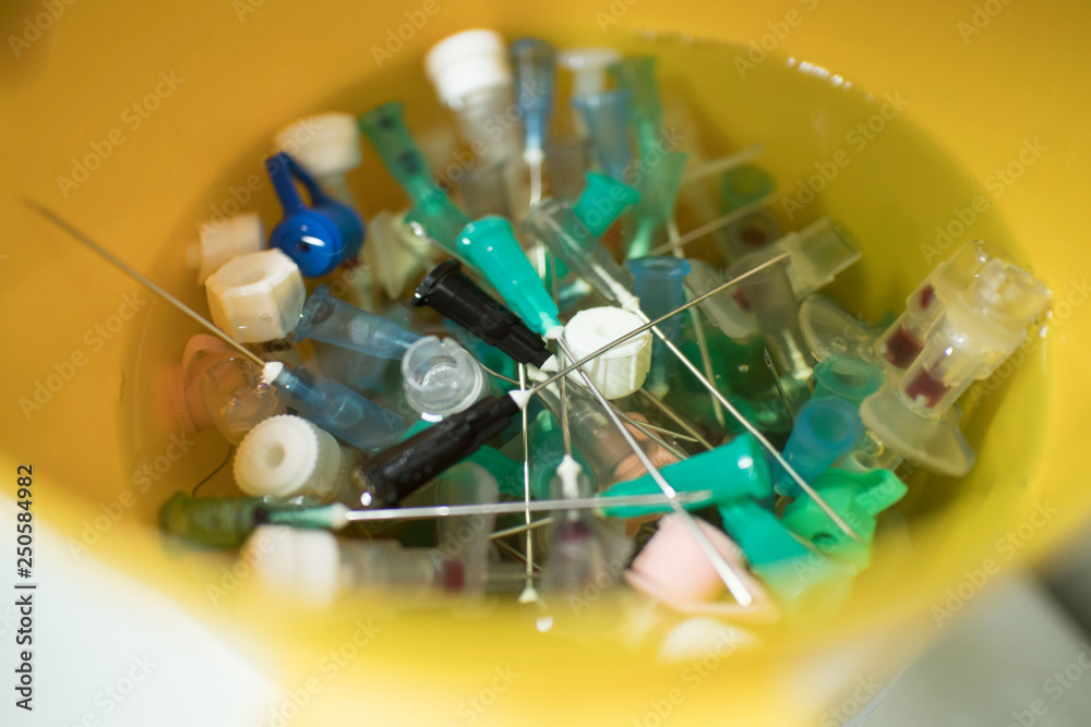 needles and syringes in disinfectant. disposal of medical needles and