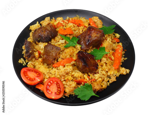 pilaf with meat on black plate isolated on white background
