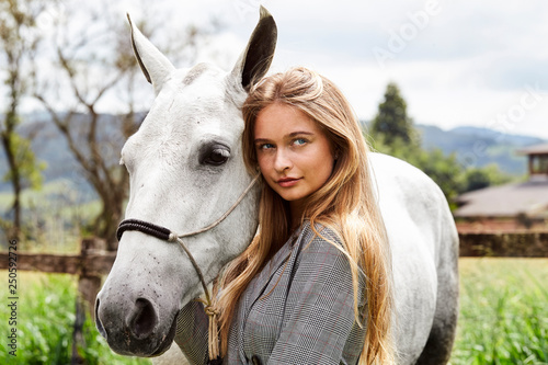 Beautiful blond woman with pony, looking at camera