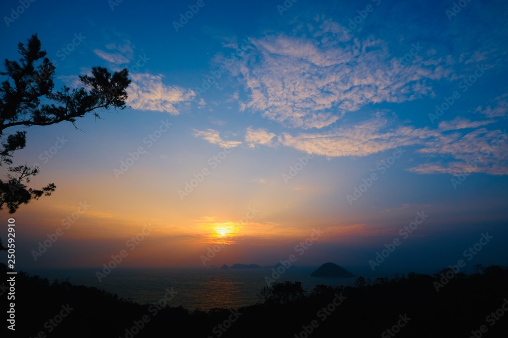 Beautiful sunrise image with colorful blue purple orange sky and white cloud with seascape landscape background