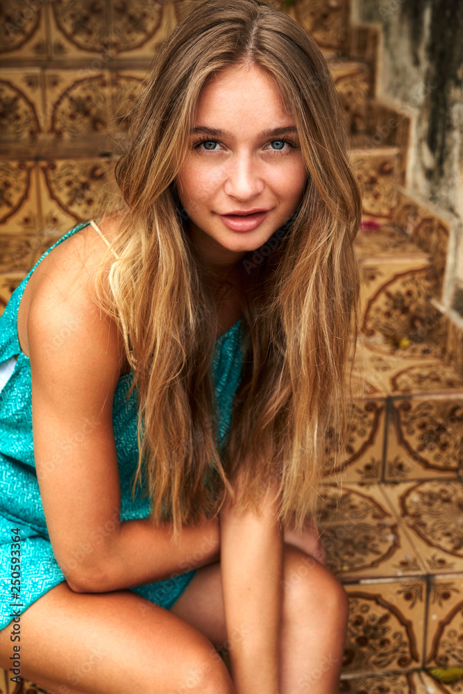 Gorgeous young woman on steps, portrait