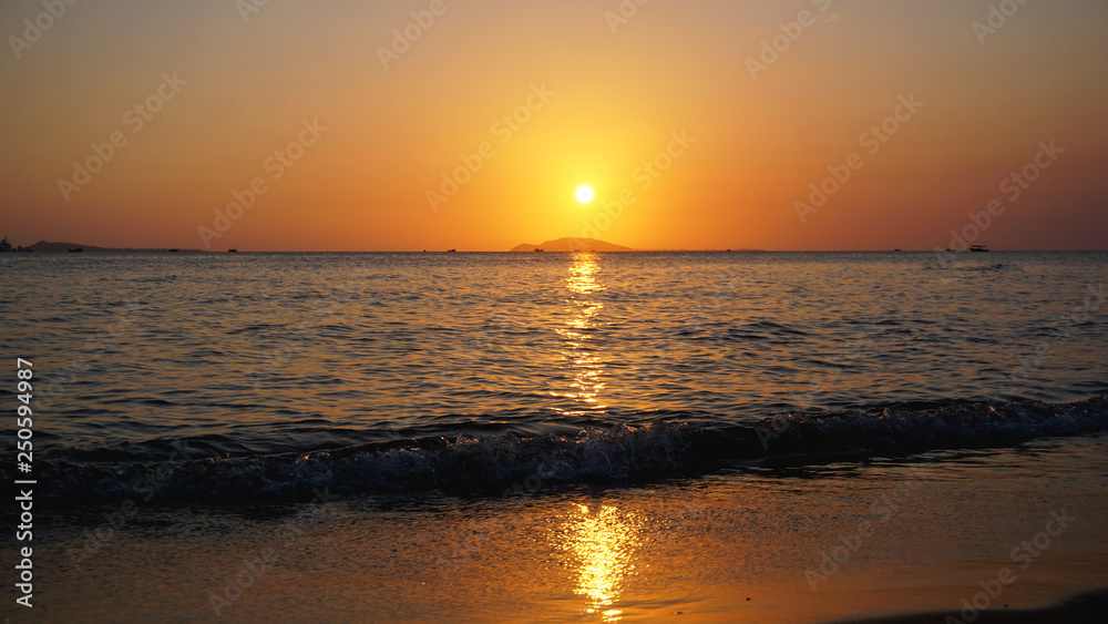 Bright sunset with yellow sun under the sea surface