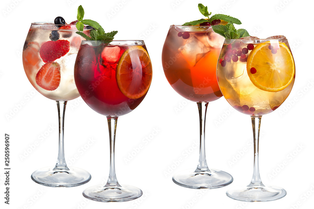 Cocktail with mint, fruits and berries on a white background. A set of four cocktails in glass glasses on a long leg. Cocktail with mint, fruits and berries on a white background. A set of four cocktails in glass glasses on a long leg.